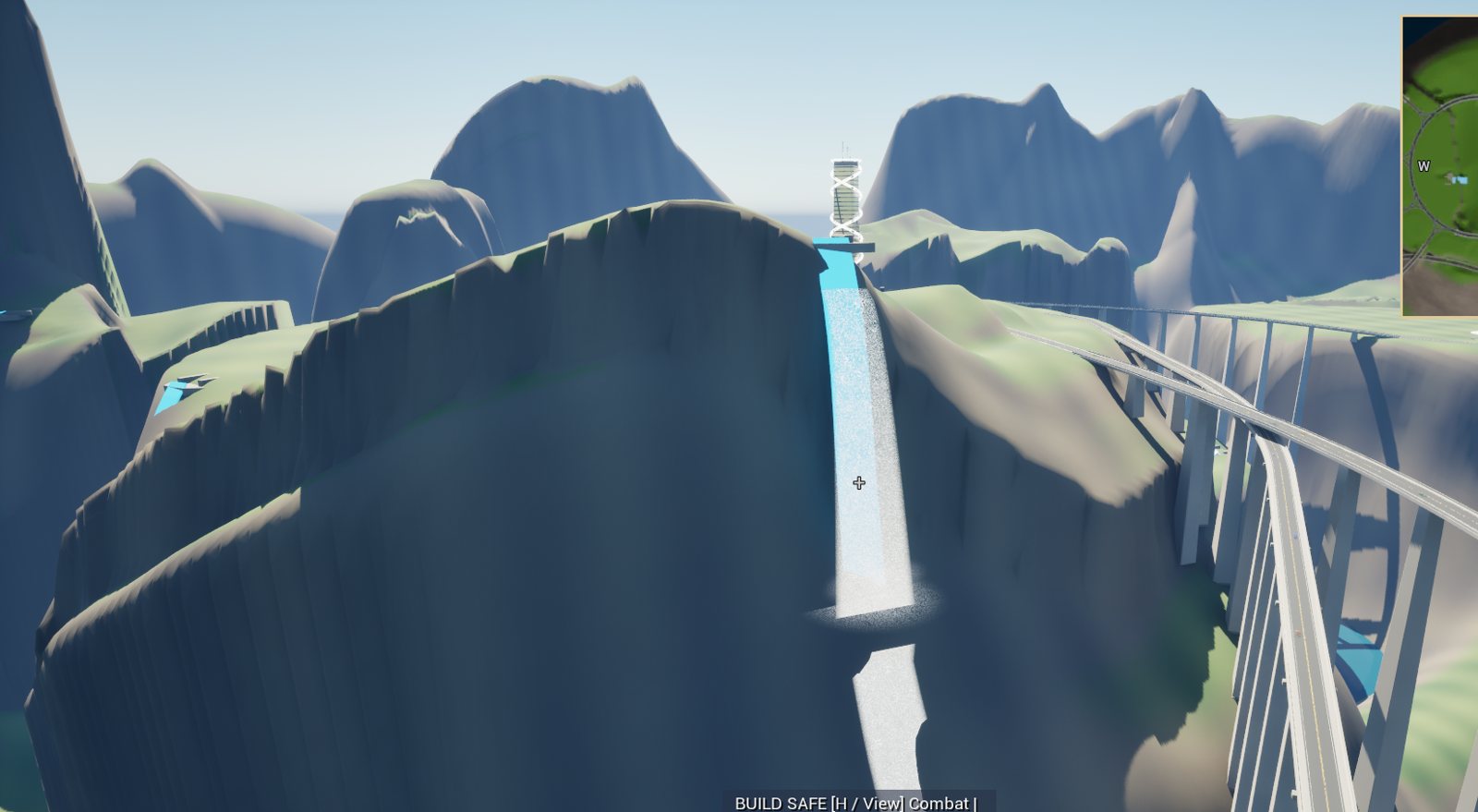 A waterfall cutting through cliffs beside a bridge